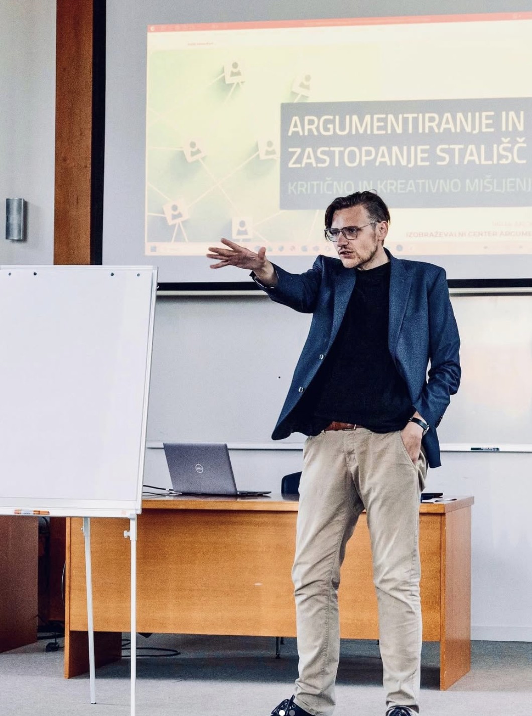 Mr. Miha Andrič lecturing in front of a whiteboard and projection